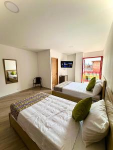 Postel nebo postele na pokoji v ubytování ALTO VERDE HOTEL