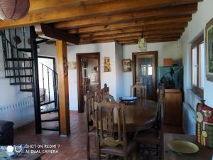a dining room with a wooden table and chairs at Villa El Salinar en Salamanca. Ideal familia/grupo in Calvarrasa de Abajo