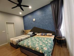 a bedroom with two beds and a ceiling fan at Cozy House in Kajang in Kajang