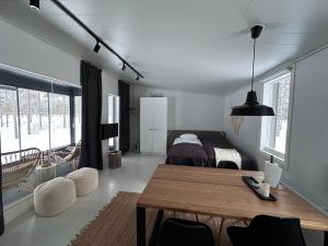 a living room with a table and a bedroom at SiikaVilla, Siikajoki in Siikajoki