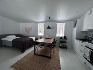 a bedroom with a bed and a table in it at SiikaVilla, Siikajoki in Siikajoki