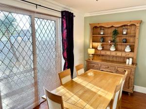a dining room with a wooden table and chairs at Beautiful 3 Bedroom House in Chester Le Street in Chester-le-Street