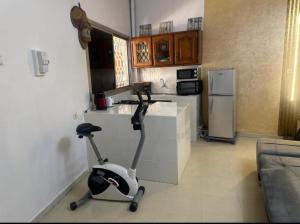 a kitchen with a exercise bike in a room at Studio meublé Corniche Mermoz in Dakar