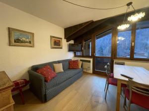 a living room with a couch and a table at 079 Bilocale, Pinzolo in Pinzolo