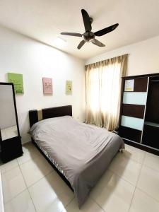 a bedroom with a bed and a ceiling fan at SR28-HousePrivate-3room-BigHouse in Bayan Lepas
