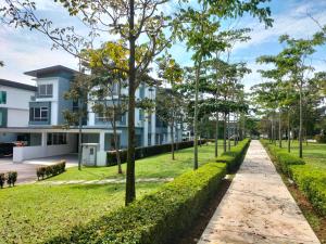 a path in front of a building with trees at Cozy House in Kajang in Kajang