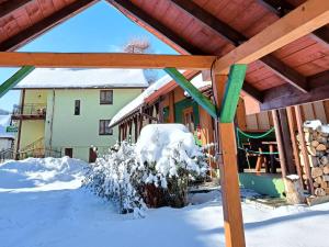 ein Haus mit Schnee auf dem Boden davor in der Unterkunft Pod Modrzewiami in Milówka