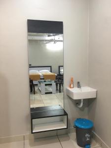 a mirror in a bathroom with a sink and a bedroom at Ajay Residency and Convention Hall / Lodge Near Me / Lodge Rayachoti in Rāyachoti