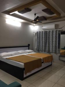 a bedroom with a bed and a ceiling fan at Ajay Residency and Convention Hall / Lodge Near Me / Lodge Rayachoti in Rāyachoti