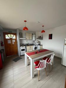 a kitchen with a table and two chairs in it at Ushuaia aparts Depto 2 in Ushuaia