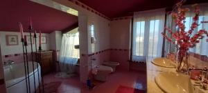 a bathroom with two sinks and a toilet and a tub at Casa Vacanze Principesca in Pescantina +41 photos
