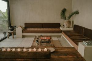 a living room with a couch and a table at TOHO VILLA 4BED WITH POOL & JACUZZI in Tulum +16 photos