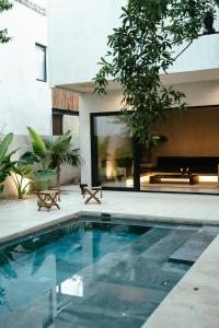 a swimming pool in front of a house at TOHO VILLA 4BED WITH POOL & JACUZZI in Tulum
