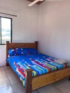 a bed with a blue comforter in a bedroom at Alojamiento Casmar cerca de playas in Palma