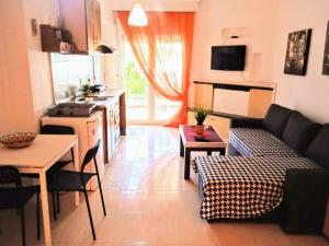 a kitchen and living room with a couch and a table at Blue Moon Apartments in Nea Michaniona