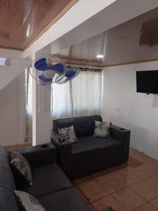 a living room with a couch and a flat screen tv at Alojamiento Casmar cerca de playas in Palma