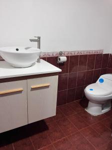 a bathroom with a sink and a toilet at Alojamiento Casmar cerca de playas in Palma