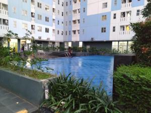 a swimming pool in the middle of a building at Urbantown Serpong Age Room in Dukuh