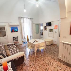 a living room with a table and a couch at Home Pugliese in Ceglie Messapica