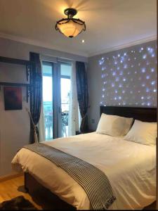 a bedroom with a large bed and a window at APARTMENT IN OCEAN VILLAGE, SLEEPS UP TO 6 in Gibraltar