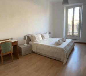 a bedroom with a bed and a desk and a window at Rome Appartement in Rome