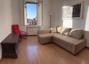 a living room with a couch and a red chair at Rome Appartement in Rome