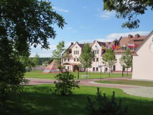 a group of houses in a park with a playground at Hotel Sulisław in Sulisław