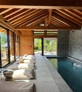 a swimming pool with a row of pillows in a house at Hôtel Restaurant La Ferme de Cupelin in Saint-Gervais-les-Bains