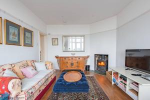 a living room with a couch and a tv at Bayside House in Westgate-on-Sea