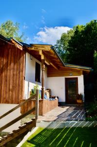 a house with a wooden fence and a porch at Anna's Appartement in Uttendorf