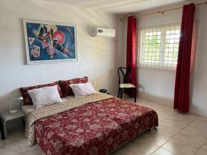 a bedroom with a bed with a red comforter at Traumhaus am Hang mit privatem Pool in Barber +31 photos