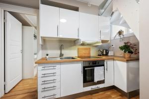 a kitchen with white cabinets and a sink at New! Modern City Apt: Central w/ Private Entrence in Bergen