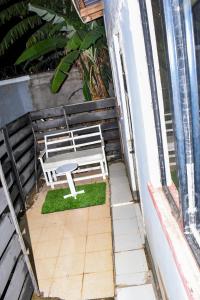 a white bench sitting on top of a balcony at Minari Holiday Homes in Bungoma
