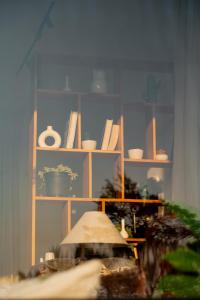 a room with a shelf with dishes on it at Sukoon Baag in Bīr