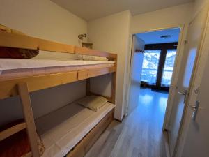 a room with two bunk beds and a hallway at Studio pieds des pistes plein soleil in Les Contamines-Montjoie