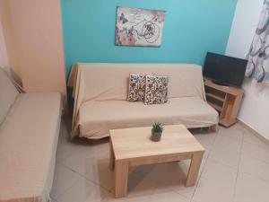 a small living room with a couch and a table at Lina's House Sivota in Sivota