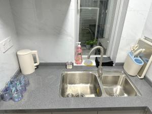 a kitchen counter top with a sink and a sink at Shanghai Shining River Apartment -Near the Bund in Shanghai