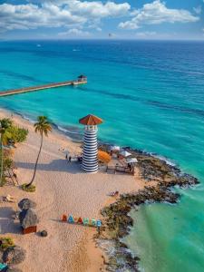an aerial view of a beach with a lighthouse at Tropical Beach Bayahibe in Bayahibe