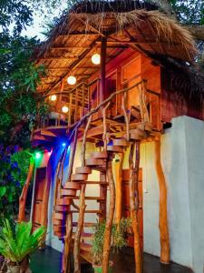 a wooden staircase leading up to a house with trees at The Banda' Eco Villa in Sigiriya