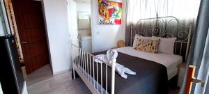 a bedroom with a bed with a crib in it at Venere Bayahibe by Mireya in Bayahibe
