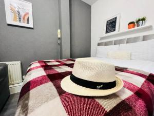 a hat sitting on top of a bed at Cosy Studio near the City Centre in Liverpool
