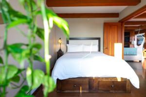 a bedroom with a bed with a white bedspread at Waterfront Condo in Ucluelet in Ucluelet