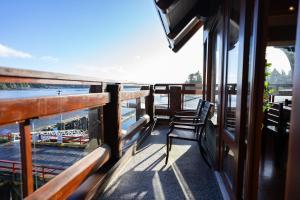 a balcony on a boat looking out at the beach at Waterfront Condo in Ucluelet in Ucluelet