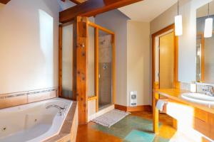 a bathroom with a tub and a sink at Waterfront Condo in Ucluelet in Ucluelet
