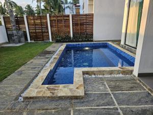 a swimming pool in the yard of a house at Kaas Villas in Dickwella