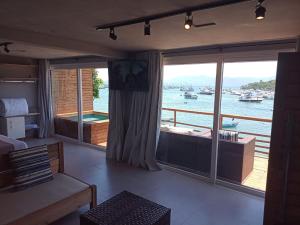 a living room with a view of the water at Caixa D'aço Exclusive in Porto Belo