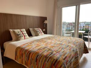 a bedroom with a large bed with a large window at Lakeview Residence 'Casa Naranjas' Mar Menor Golf and Leisure Resort in Torre-Pacheco +41 photos