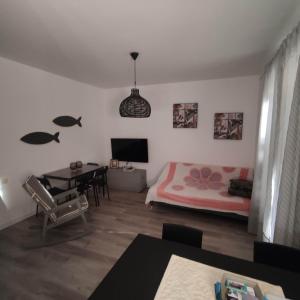 a living room with a bed and a table at Casa BLU B7 4 in La Maddalena