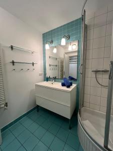 a bathroom with a sink and a mirror and a tub at Villa Parkblick App. 4 in Kühlungsborn +7 photos