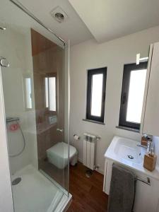 uma casa de banho com um chuveiro, um WC e um lavatório. em NEW! Feel the Ocean Design Apartment em Pataias